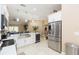Stylish kitchen features stainless steel appliances, a wine cooler, and connects to living spaces at 11913 Butler Woods Cir, Riverview, FL 33579