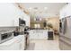 Open kitchen boasts stainless appliances, white cabinets, and seamless flow to living areas at 11913 Butler Woods Cir, Riverview, FL 33579