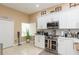 Bright kitchen boasts stainless appliances, white cabinets, and ample counter space at 11913 Butler Woods Cir, Riverview, FL 33579