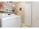 Clean laundry room features washer, dryer, and ample storage shelving at 11913 Butler Woods Cir, Riverview, FL 33579