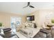 Comfortable living room with a ceiling fan, sliding glass doors to the patio, and neutral walls at 11913 Butler Woods Cir, Riverview, FL 33579