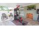 Covered patio with fitness equipment, a lounge area, and ceiling fan at 11913 Butler Woods Cir, Riverview, FL 33579