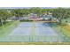 Aerial view of well-maintained tennis courts surrounded by green spaces, playground, and dog park at 11913 Butler Woods Cir, Riverview, FL 33579