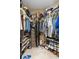 Organized walk-in closet with shelving and hanging space for clothes and shoes at 11913 Butler Woods Cir, Riverview, FL 33579