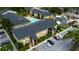 Aerial view of condo buildings, showing parking, community pool, landscaping at 12261 Sailwinds Dr # 203, Largo, FL 33773