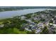 Expansive aerial shot of a residential complex with a pool, nestled near a serene lake and mature trees at 12261 Sailwinds Dr # 203, Largo, FL 33773