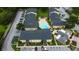 Overhead view of apartment buildings surrounding a sparkling pool with lounge area and parking at 12261 Sailwinds Dr # 203, Largo, FL 33773