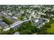 Drone shot of a well-maintained apartment community with a central pool and beautifully landscaped grounds at 12261 Sailwinds Dr # 203, Largo, FL 33773