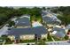 Aerial view of community featuring multiple buildings, a pool area, and lush landscaping at 12261 Sailwinds Dr # 203, Largo, FL 33773