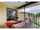 Comfortable screened balcony seating area with outdoor furniture and sliding glass doors to the Primary bedroom at 12261 Sailwinds Dr # 203, Largo, FL 33773