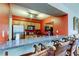 Wet bar featuring granite countertops, wood cabinets, stainless steel appliances, and bar stool seating at 12261 Sailwinds Dr # 203, Largo, FL 33773