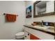 Bathroom features a sleek vanity with a marble countertop and framed mirror at 12261 Sailwinds Dr # 203, Largo, FL 33773