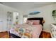 Comfortable bedroom showcasing a cozy bed, stylish decor, and a glimpse into the bathroom at 12261 Sailwinds Dr # 203, Largo, FL 33773