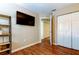 This bedroom has wood floors and a closet at 12261 Sailwinds Dr # 203, Largo, FL 33773