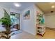Hallway showcasing tile flooring and a sliding glass door to the balcony with natural light at 12261 Sailwinds Dr # 203, Largo, FL 33773