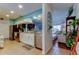 Updated kitchen featuring white cabinets, stainless steel appliances, and views into the living room at 12261 Sailwinds Dr # 203, Largo, FL 33773