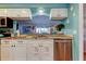 Kitchen area featuring granite countertops, stainless steel appliances, and views to the dining area at 12261 Sailwinds Dr # 203, Largo, FL 33773