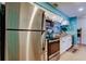 Bright kitchen features stainless steel appliances, white cabinets, and light countertops at 12261 Sailwinds Dr # 203, Largo, FL 33773