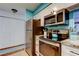 Well-equipped kitchen featuring stainless steel appliances and white cabinets, maximizing storage space at 12261 Sailwinds Dr # 203, Largo, FL 33773