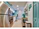 Well-lit kitchen features stainless steel appliances, white cabinets, and tiled floor at 12261 Sailwinds Dr # 203, Largo, FL 33773
