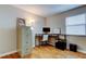 Office features a modern black desk, rolling chair, filing cabinet, and natural light at 12261 Sailwinds Dr # 203, Largo, FL 33773
