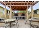 Community outdoor grill with covered seating area and brick paved patio at 12261 Sailwinds Dr # 203, Largo, FL 33773