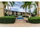 Inviting community pool and spa area surrounded by lush landscaping and palm trees at 12261 Sailwinds Dr # 203, Largo, FL 33773