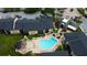 Aerial view of a community pool and lounge area, surrounded by palm trees and well-kept landscaping at 12261 Sailwinds Dr # 203, Largo, FL 33773