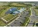 Stunning aerial view of community amenities, pool, pond, clubhouse, park and recreational area at 12586 Somatic Ct, Venice, FL 34293