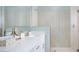 This pristine bathroom offers a dual vanity with quartz countertop and a spacious walk-in shower at 12586 Somatic Ct, Venice, FL 34293