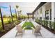 Inviting courtyard featuring Adirondack chairs, a cornhole game, and string lights for relaxing outdoor community space at 12586 Somatic Ct, Venice, FL 34293
