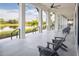 Relaxing covered patio featuring comfortable Adirondack chairs and scenic waterfront views at 12586 Somatic Ct, Venice, FL 34293