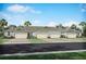 A row of newly built single story homes featuring attached garages and neatly paved driveways at 12586 Somatic Ct, Venice, FL 34293