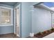 Exterior view of a home's entrance with a window and a partially open glass door at 12586 Somatic Ct, Venice, FL 34293