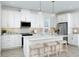 Bright kitchen featuring white cabinetry, stainless steel appliances, and a center island with seating at 12586 Somatic Ct, Venice, FL 34293