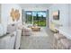 Bright living room with a sectional sofa and dining table, leading to an outdoor screened-in patio at 12586 Somatic Ct, Venice, FL 34293