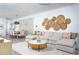 Spacious living room with a large sectional sofa, dining table, and stylish decor at 12586 Somatic Ct, Venice, FL 34293