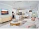 Open-concept living room connected to a kitchen, featuring modern furnishings and decor at 12586 Somatic Ct, Venice, FL 34293