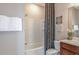 This bathroom has a shower and bath combination, with modern decor and a dark wood cabinet at 13740 Rocky Pine Pl, Spring Hill, FL 34610