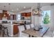 Bright kitchen features stainless appliances, a large island, and seamless flow to dining area at 13740 Rocky Pine Pl, Spring Hill, FL 34610