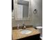 Bathroom features a granite countertop, mosaic mirror, and a white toilet at 1400 Pine Glen Ln # D2, Tarpon Springs, FL 34688
