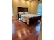 Cozy bedroom with wood floors, large windows and comfortable furnishings at 1400 Pine Glen Ln # D2, Tarpon Springs, FL 34688