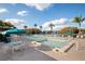 Community pool with lounge chairs and umbrellas on a sunny day at 1400 Pine Glen Ln # D2, Tarpon Springs, FL 34688