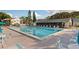 Large community pool with seating, sunning deck and nearby building at 1400 Pine Glen Ln # D2, Tarpon Springs, FL 34688