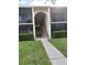 Charming condo featuring a private screened-in porch, lush landscaping, and well-maintained grounds at 1400 Pine Glen Ln # D2, Tarpon Springs, FL 34688