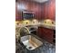 Stylish kitchen featuring stainless steel appliances, stone backsplash, granite countertop and modern fixtures at 1400 Pine Glen Ln # D2, Tarpon Springs, FL 34688