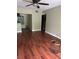 Open-concept living room showcases hardwood floors, neutral walls, and a modern accent table at 1400 Pine Glen Ln # D2, Tarpon Springs, FL 34688