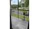 Screened-in patio has stone tiles and views of the parking lot and greenery at 1400 Pine Glen Ln # D2, Tarpon Springs, FL 34688