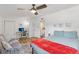 Bright bedroom featuring a desk, a comfortable queen-sized bed, and a relaxing seating area at 1438 Poinciana Dr, Clearwater, FL 33764