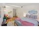 Well-lit bedroom with laminate flooring, ample space, and cozy decor at 1438 Poinciana Dr, Clearwater, FL 33764
